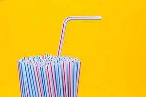 Drinking plastic straws on a yellow background photo