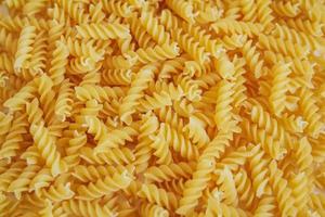 Fusilli pasta as background image. Image texture spiral macaroni photo