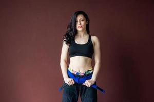 Portrait beautiful athletic woman with blue belt photo
