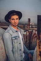 Urban man with hat against the background of city photo