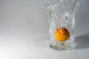Mandarin in a glass with water photo