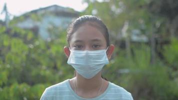 Portrait girl wearing face masks looking at camera.