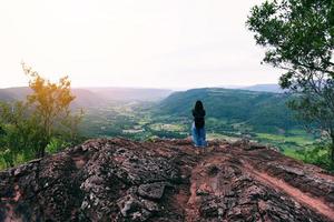 Backpacking woman on mountain - Hiker on rock above valley , Woman watch morning valley to bright morning Sun Tourist looking to valley bellow autumn landscape weather beautiful mountain photo