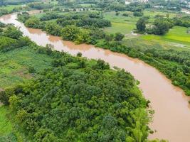 Aerial view river flood forest nature woodland area green tree, Top view river lagoon pond with water flood from above, Bird eye view landscape jungles lake flowing wild water after the rain photo