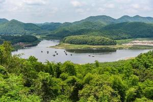 Landscape of river mountain and bamboo houseboat raft floating on riverside at a lake for relax in holiday - Huay Kra Ting landmark of Loei Thailand photo