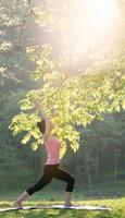 young beautiful asian woman practicing yoga photo