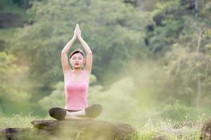 young beautiful asian woman practicing yoga photo