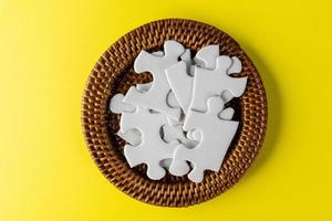 White jigsaw puzzle in container photo