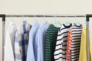 Pastel kid shirts hanging on rack photo