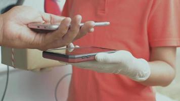 Hand of a man using QR code scanner with mobile device for payment. video