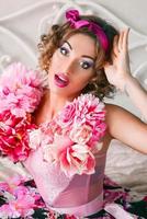 portrait of young woman in colorful dress with flowers on it in doll style photo