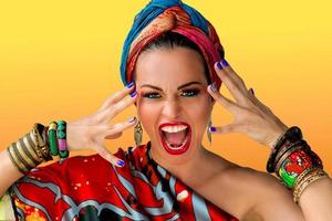 Portrait of screaming young attractive woman singer in african style on colorful background photo