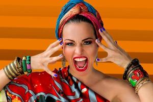 Portrait of screaming young attractive woman singer in african style on colorful background photo