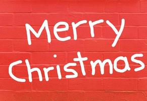 Merry Christmas over red brick wall photo