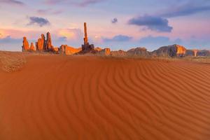 Totem pole and sand dunes  in Monument Valley, Arizona USA photo