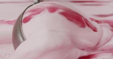 Close-up of a scoop on the melting strawberry-flavored ice cream