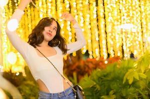 Asian female portrait with lights at night photo