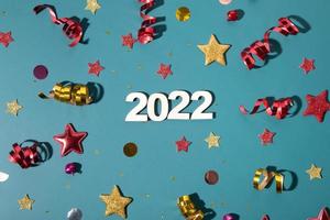 2022 number flat lay with colorful sparkles, stars, streamers festive background photo