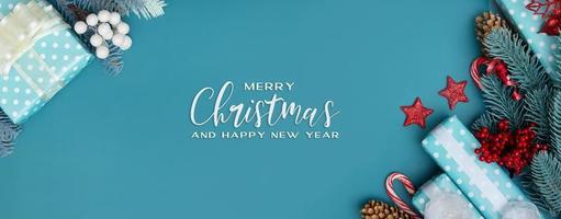 Merry Christmas inscription greeting banner with flat lay Christmas gift, berries and pine photo