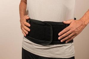 Man wearing a Back Brace for his injured back, Back Pain treatment photo