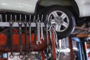 Wrench hanging on the mechanic's table in the garage. photo