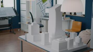 Table with building model and maquette presentation in empty architectural space video