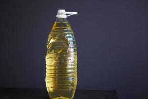 sunflower oil bottle on table against gray background photo