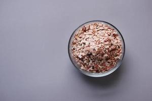 red Flattened rice in a bowl on gray background photo