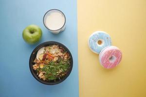 comparing healthy and junk food concept on table photo