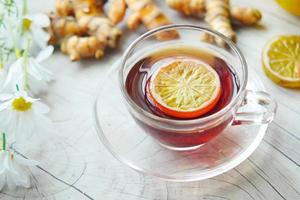 Top view of ginger tea on wooden background. photo