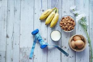 eggs in a plastic container, milk and almond nut in table photo