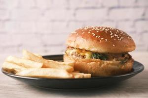 junk foods on plate on wooden table close up photo