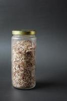 red Flattened rice in a jar on table photo