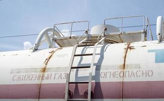 Oil transportation. Natural gas storage tank. Cargo tanks at the railway station. Business concept. Text in Russian liquefied gas, flammable. Ukraine, Kiev - August 10, 2021. photo