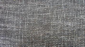 Close-up of gray fabric texture, background and wallpaper. The texture of the fabric is gray, textile upholstery. Gray tweed texture, gray wool pattern photo