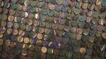 Macro close up of sparkles. Abstract background with gray sparkles. Texture scales of round spangles with color transition. Sequin background. Template for design. Festive background. photo