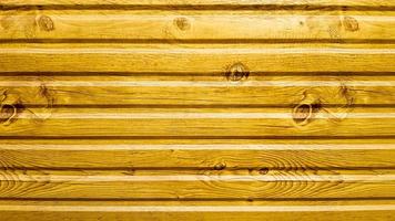 Light yellow painted wood texture, seamless textured pattern. The wall of bright yellow horizontal boards is laid horizontally. photo