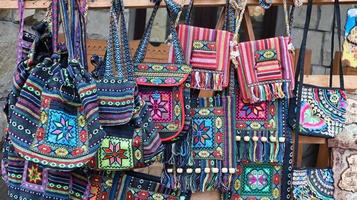 Souvenir market in Yaremche. Shoulder bags with ethnic Ukrainian designs are on sale in the Carpathians. Ukraine, Yaremche - November 20, 2019 photo