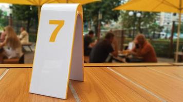 the order number on the table on the street in a McDonald's restaurant. Awaiting an order at a McDonald's restaurant. Fast food with invoice, check. Ukraine, Kiev - September 6, 2019. photo