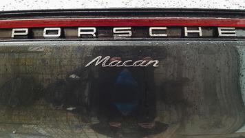 Ukraine, Kiev - March 27, 2020. Porsche Macan sports black car detailed rear view of the body with a logo. photo