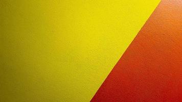 Red and yellow painted wall texture abstract grunge background with copy space. Abstract geometric pattern on the wall. The wall is divided into borders of different colors photo