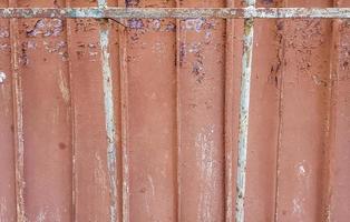 Texture of the old concrete wall for background. Reinforced concrete with damaged and rusty metal fittings photo