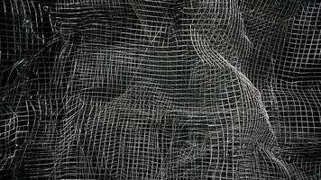 Crumpled mesh. Abstract background. Metal mesh with shadow on a black background. The surface of a large roll is damaged by wire mesh. photo