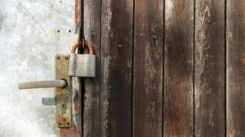 Details of old doors of a wooden house with padlocks. Copy space. photo