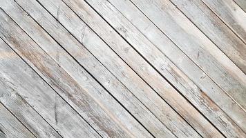 Gray wooden background with diagonal lines. Board background with copy space. Wooden old boards with cracked gray paint on the diagonal. Selective focus. Textured wooden background. photo