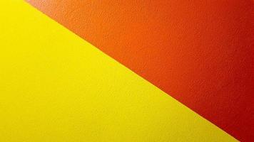 Red and yellow painted wall texture abstract grunge background with copy space. Abstract geometric pattern on the wall. The wall is divided into borders of different colors photo