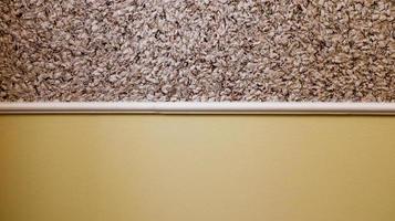decorative plaster and semi-painted wall in beige. Textured background. Two color wall. The yellow and beige background is painted in two different colors. Abstract wallpaper. copy space photo