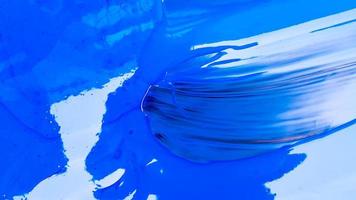 Abstract background of spilled blue paint with buckets on a black background. Blue paint is pouring on a black background. Use it for an artist or creative concept. Paints spilled blue background photo