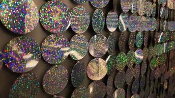 Macro close up of sparkles. Abstract background with gray sparkles. Texture scales of round spangles with color transition. Sequin background. Template for design. Festive background. photo