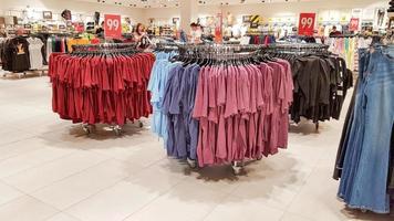 Ukraine, Kiev - September 04, 2019. A large clothing store, mannequins and many rows with hangers, a variety of sizes and colors. Black Friday, a day of shopping and sales at boutiques and malls photo